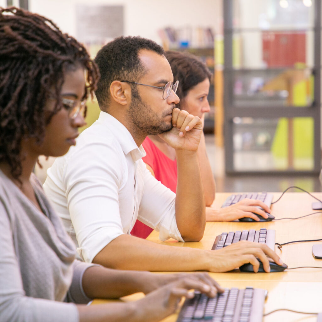 Three people on computers