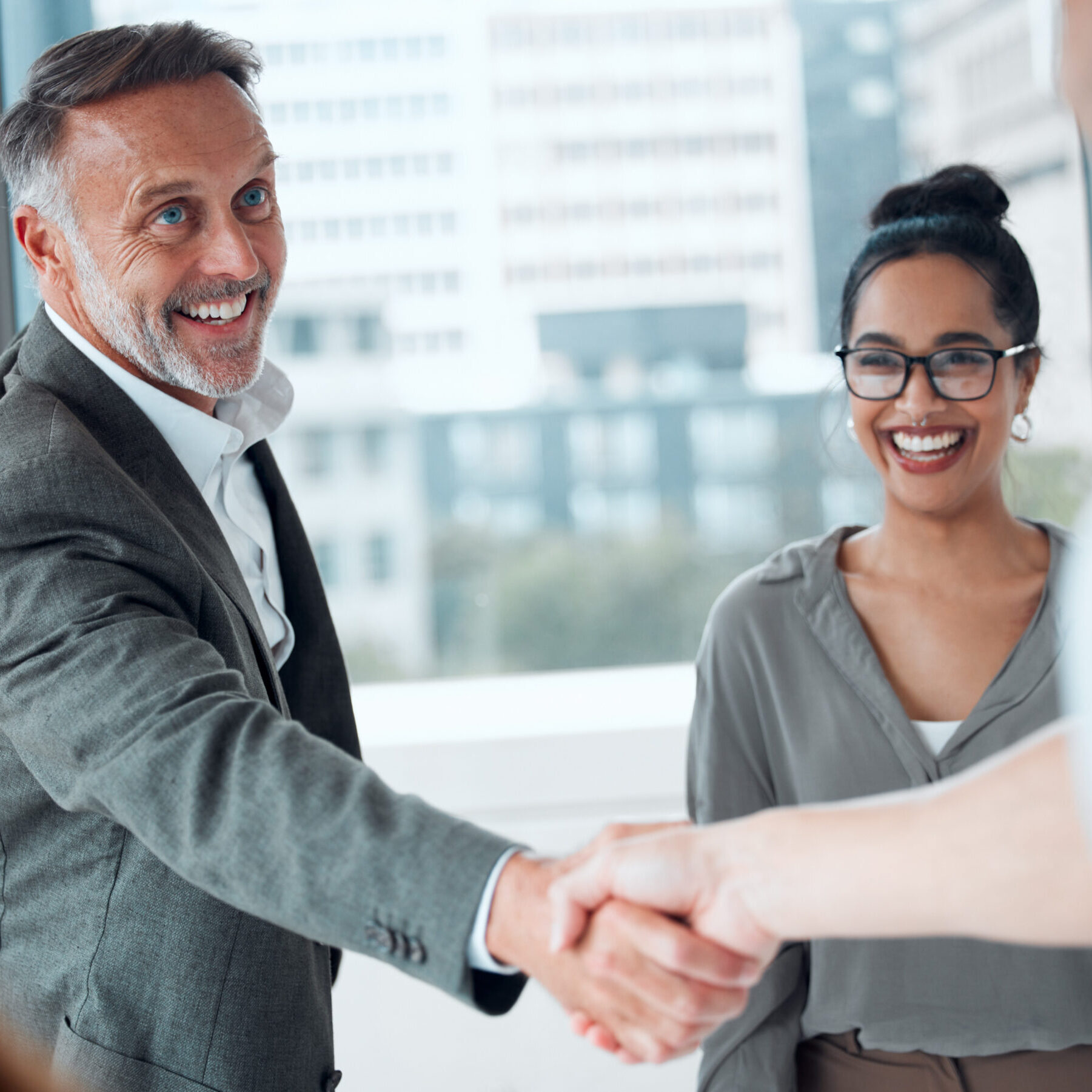 Handshake, meeting and welcome with business man in office for hiring, management or recruitment. Contract, partnership and promotion deal with mature employee shaking hands for b2b collaboration.